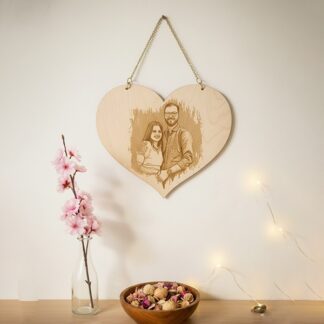 A personalized wooden heart photo plaque with engraved image of a couple, perfect for sentimental gi.