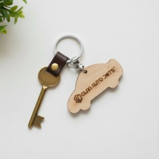 Custom engraved wooden car-shaped keyring with logo.