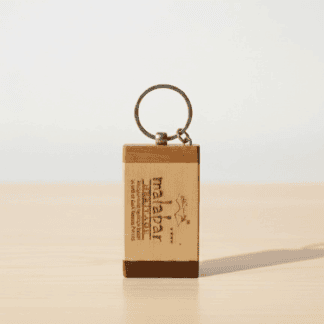 Personalized wooden keyring with engraved logo for corporate branding.