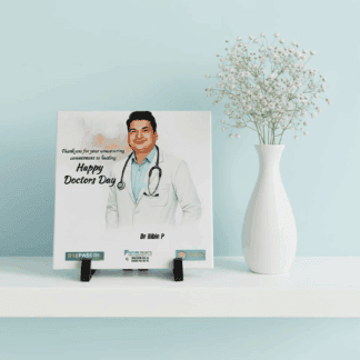 Personalized doctor recognition tile on easel stand with floral arrangement.