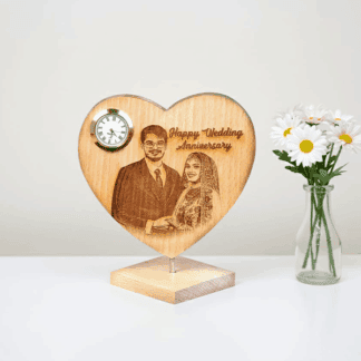 Personalized wedding anniversary clock with couple's engraving.