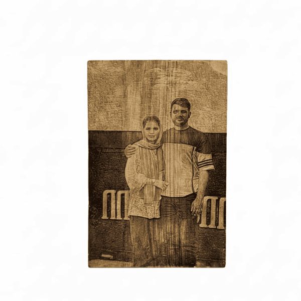 Personalized wood photo frame with laser engraving of a couple's portrait.